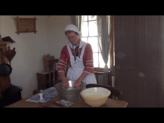 Jenni doing the dishes and talking to visitors